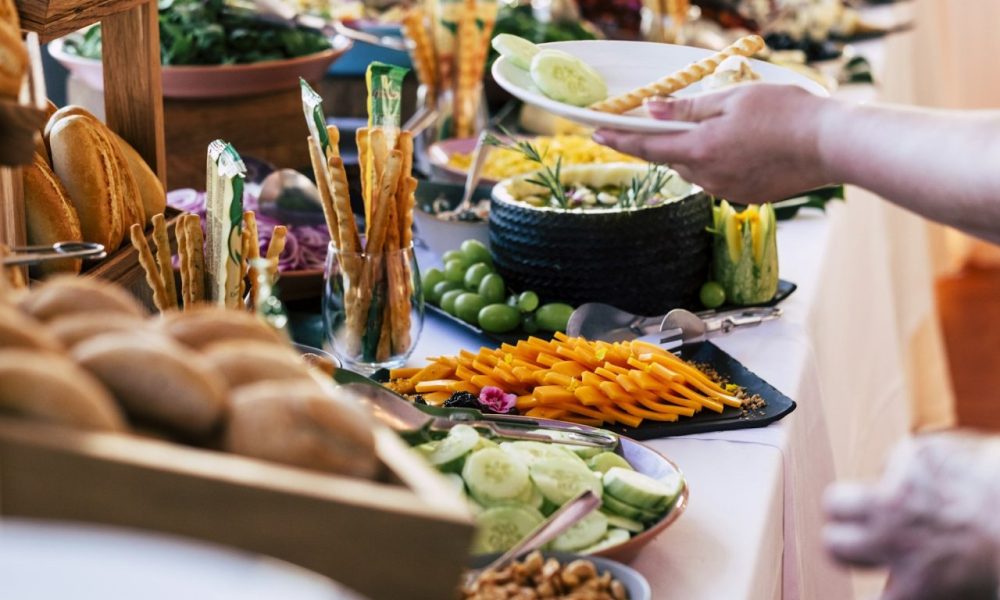 close-up-of-people-taking-food-from-table-at-event-party-with-catering-self-service