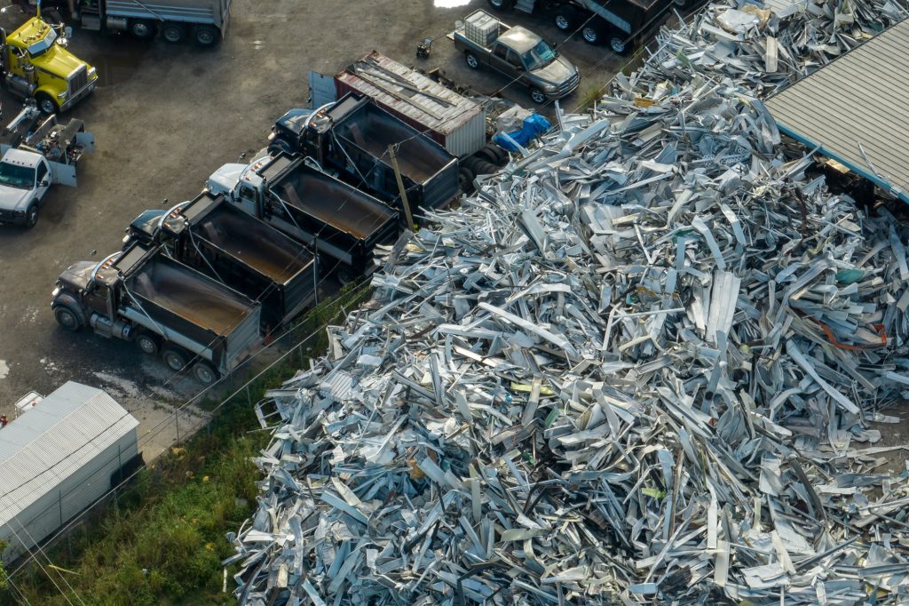 Beg pile of scrap aluminum metal siding from ruined houses after hurricane Ian